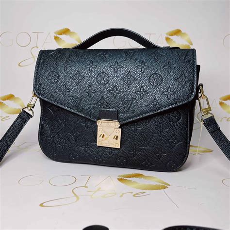 black embossed lv purse.